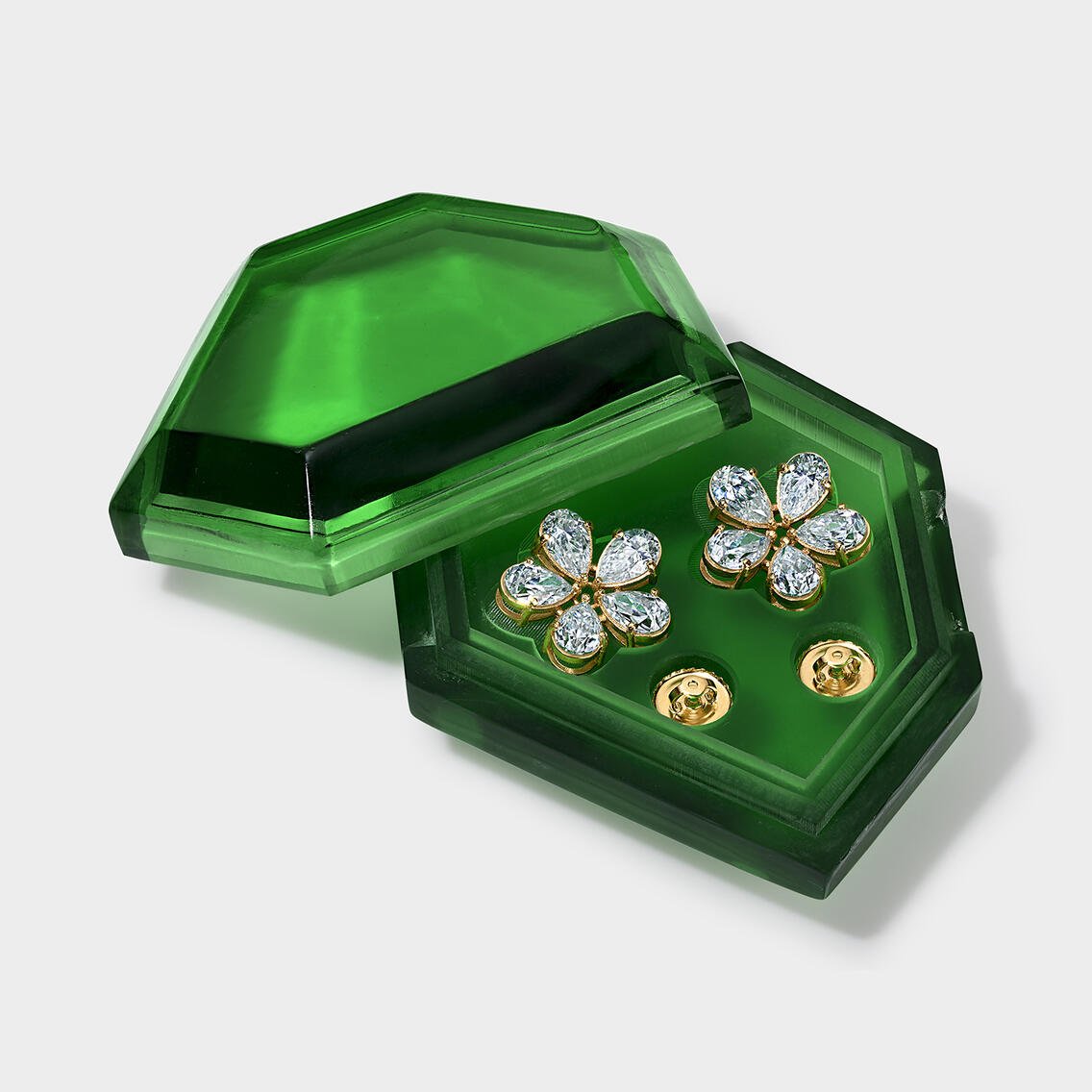 Diamond flower stud earrings in a green glass jewelry box