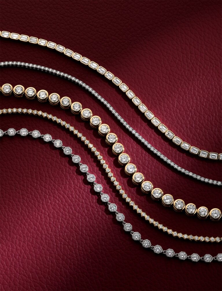 Diamond tennis bracelets in mixed metals arranged on burgundy leather