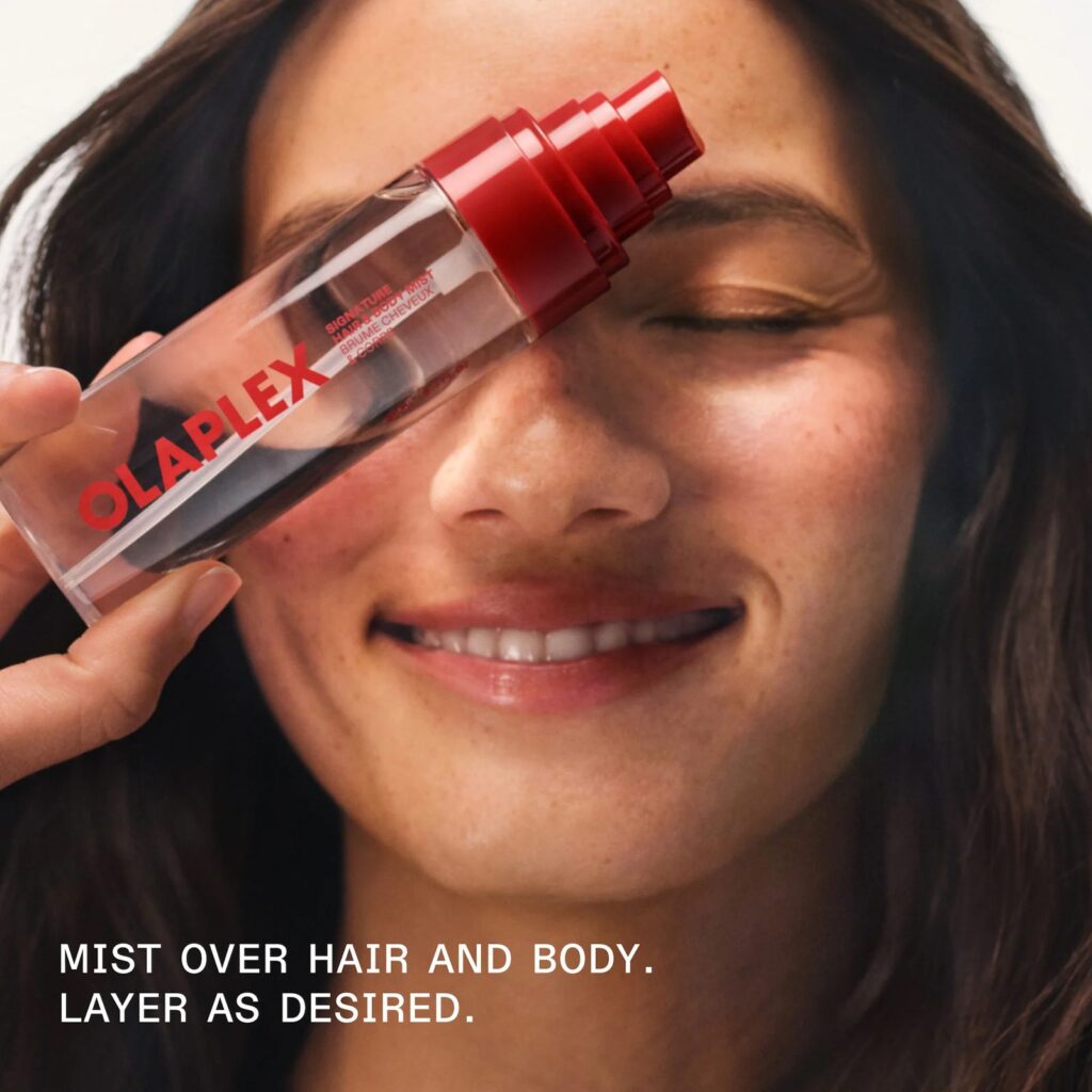 Model misting Olaplex Signature Hair & Body Mist over hair and body