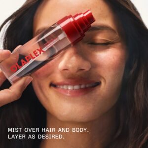 Model misting Olaplex Signature Hair & Body Mist over hair and body